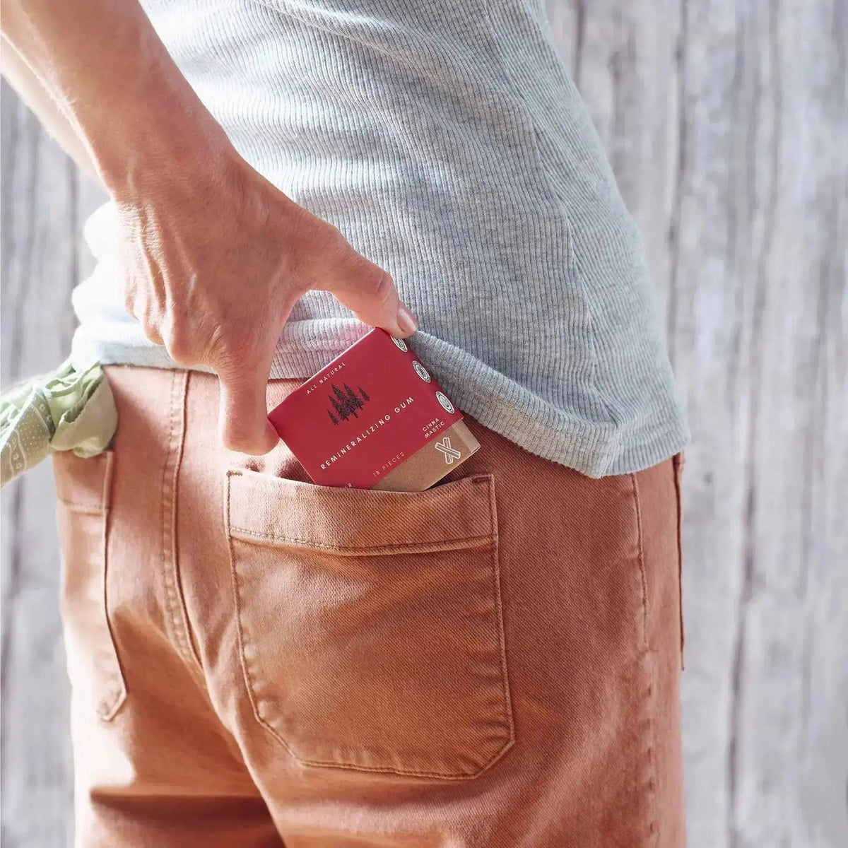 eknest cinna mastic remineralizing gum being placed in back pocket