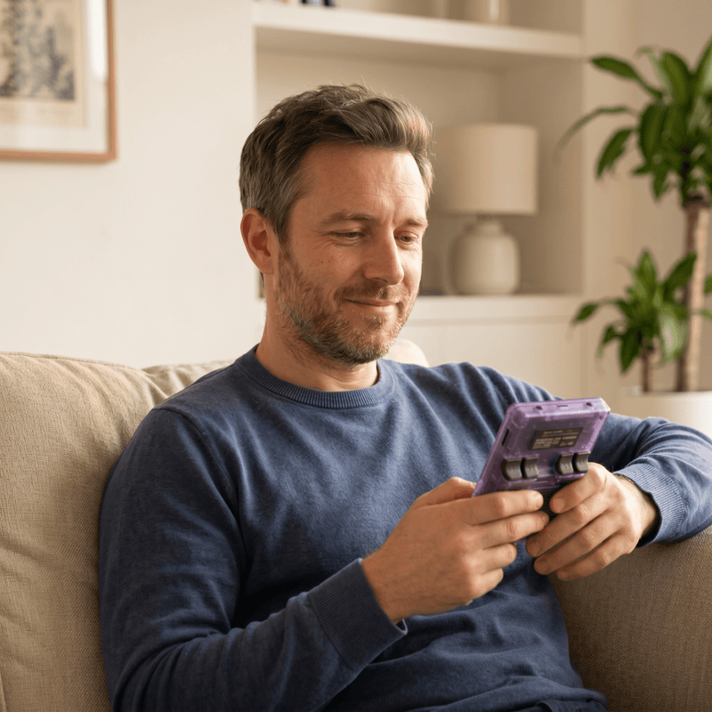 Person playing the Eknest Pro 2.0 R36S retro gaming console at home